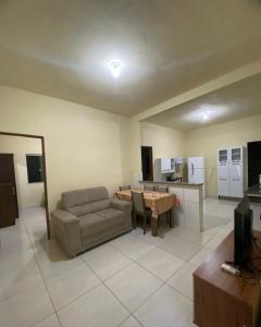 a living room with a couch and a table at Casa disponível para temporada in São Roque de Minas
