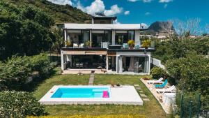 a house with a swimming pool in the yard at Sublima Villa, Luxe et élégance in La Gaulette