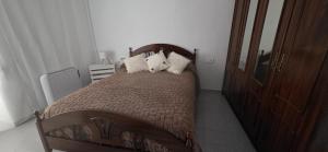 a bedroom with a bed with three pillows on it at Vivienda Turística de Alojamiento Rural - Labrucena in Abrucena