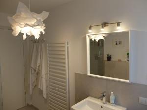 a bathroom with a sink and a mirror at Dream Home - Kapuziner Platz in Brunico +18 photos