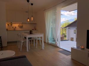 a kitchen and living room with a white table and chairs at Dream Home - Kapuziner Platz in Brunico