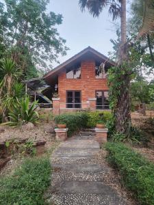 a brick house with a pathway in front of it at Little Bro Mae Hong Son in Ban Mai