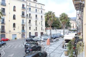 a city street with cars parked in a parking lot at La Vinella in Lamezia Terme