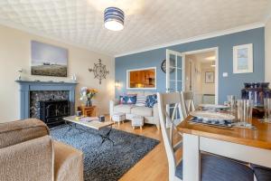 a living room with a table and a fireplace at 2 Bed in Reedham oc-c29528 in Haddiscoe