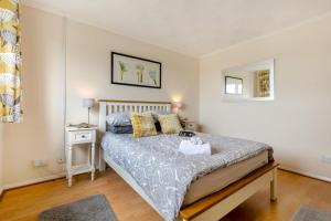 a bedroom with a large bed and a night stand at 2 Bed in Reedham oc-c29528 in Haddiscoe