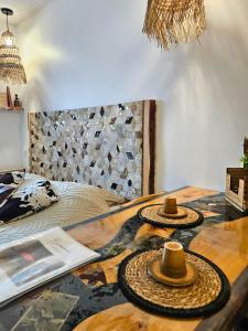 two hats on a table in a room with a bed at [Chalet] Studio Premium, WIFI, Chaleureux in Lourdes
