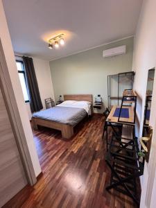a bedroom with a bed and a wooden floor at Dormire a Reggio zona Aeroporto in Reggio di Calabria +40 photos