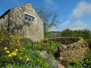 a stone building with a window in a field of flowers at 1 Bed in Broughton oc-b30218 in Broughton