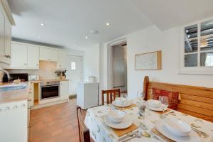 a kitchen and dining room with a table and chairs at 3 Bed in Westleton oc-swc in Westleton