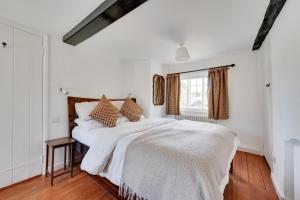 a white bedroom with a large bed and a window at 3 Bed in Westleton oc-swc in Westleton