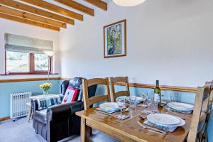 a dining room with a wooden table and chairs at 2 Bed in Aberystwyth oc-99869 in Devils Bridge