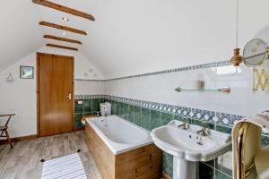 a bathroom with a sink and a bath tub at 2 Bed in Aberystwyth oc-99869 in Devils Bridge +26 photos
