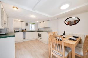 a kitchen and dining room with a wooden table at 3 Bed in St Ives oc-pc1016 in St Ives