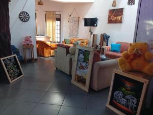 a living room with pictures on the floor at Samee Villa & Hostel Airport in Seeduwa