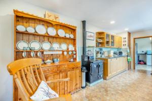 a kitchen with a wooden wall with dishes on it at 4 Bed in Tywyn oc-23385 in Llanfihangel-y-Pennant