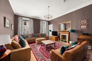 a living room with a couch and a fireplace at 6 Howard Place in St. Andrews