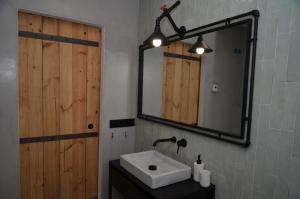 a bathroom with a sink and a mirror at Búnker de Pepa in Zamora +21 photos