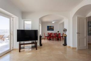 a living room with a flat screen tv on a table at Villa Acantilado Cabo de Palos in Cabo de Palos