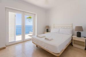 a bedroom with a bed with a view of the ocean at Villa Acantilado Cabo de Palos in Cabo de Palos