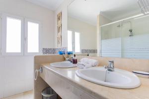 a bathroom with two sinks and a large mirror at Villa Acantilado Cabo de Palos in Cabo de Palos +39 photos