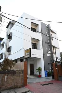 a white building with a sign in front of it at TTAMAASHA INNN in Chinhat
