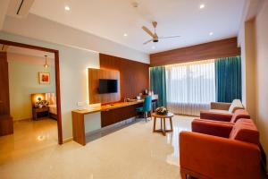 a living room with a couch and a desk at Hotel dreamland residency in Kottayam +17 photos