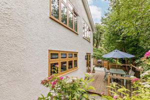 a patio with a table and an umbrella next to a building at 2 Bed in Beer oc-s27769 in Beer