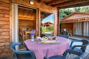 a table with a purple table cloth on a patio at Camping Prades Park in Prades