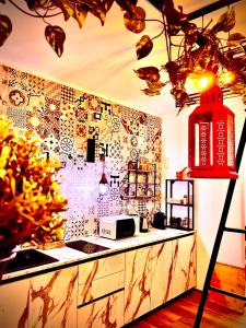 a kitchen with a counter and a wall covered in tiles at La Macchia sui Sassi in Matera