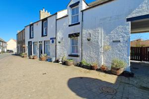 a street with potted plants on the side of a building at 2 Bed in Coldingham oc-c31971 in Coldingham