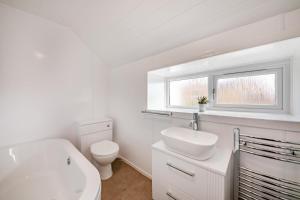 a white bathroom with a toilet and a sink at 2 Bed in Coldingham oc-c31971 in Coldingham +15 photos