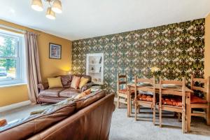 a living room with a couch and a table at 2 Bed in Staffield oc-j32453 in Kirkoswald