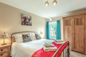 a bedroom with a large bed and a window at 2 Bed in Staffield oc-j32453 in Kirkoswald