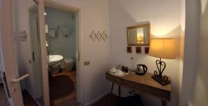 a bathroom with a sink and a table with a lamp at Civico 10 in Gubbio +55 photos
