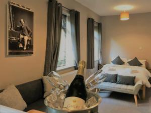 a bottle of wine on a table in a living room at The Milestone in Sowerby Bridge