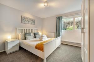 a bedroom with a white bed and a window at 3 Bed in Croyde oc-f33111 in Croyde
