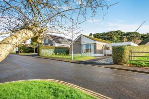 an empty street in a residential neighborhood with a tree at 3 Bed in Croyde oc-f33111 in Croyde
