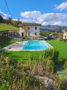 a house with a swimming pool in a yard at Agriturismo Cascina Lella in Varzi