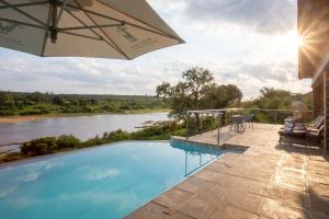 a swimming pool with a view of a river at Buffalo Brooke in Hectorspruit