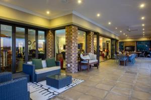 a lobby of a hotel with chairs and tables at Buffalo Brooke in Hectorspruit