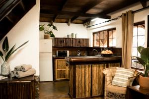 a kitchen with wooden cabinets and a counter top at LittleBush Private Lodge in Hoedspruit