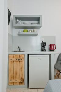 a kitchen with a white counter and a white refrigerator at Naxos Diol in Naxos Chora