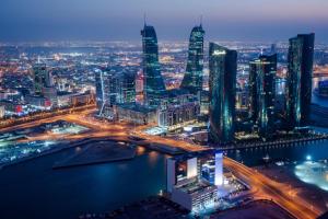 a night view of a city with tall buildings at Bab Al Bahrain Hotel in Manama