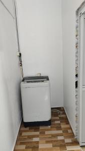 a small refrigerator sitting on a floor in a room at Seetha's Homestay in Lunas +3 photos