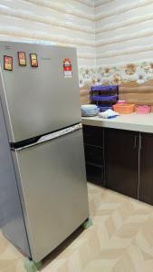 a refrigerator in a kitchen with a counter at Seetha's Homestay in Lunas