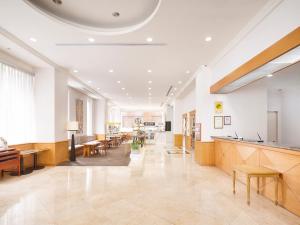 a large lobby with tables and chairs in a building at Hotel Sunroute Taipei in Taipei