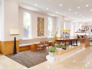 a dining room with tables and chairs and windows at Hotel Sunroute Taipei in Taipei