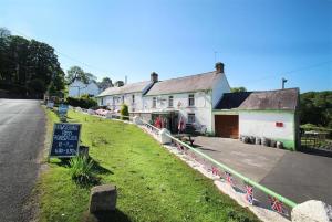 a house on the side of a road with a sign at 2 Bed in Llanmadoc oc-hh469 in Llanmadoc