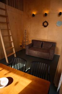 a living room with a table and a couch at Chateau Chapiteau in Gudzhareti