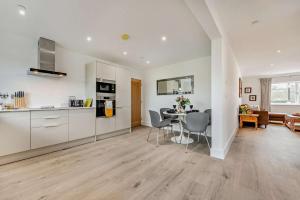 a kitchen and living room with a table and chairs at 2 Bed in Llanarthney oc-c28877 in Llanarthney